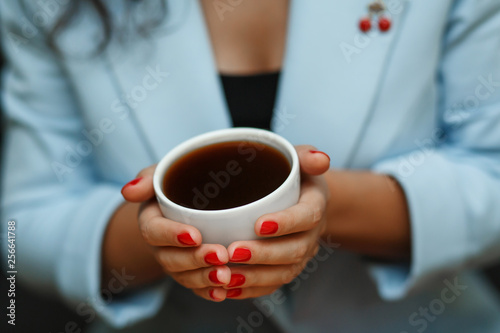 top view woman in blue jacket hold cup of coffee