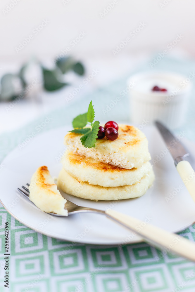 Homemade cheese pancakes on a white plate Homemade cheese pancakes on a white plate