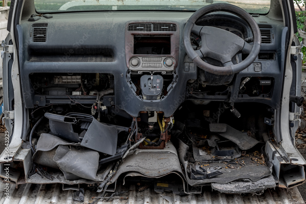 Fototapeta premium wrecked car front covered in dust cut in half