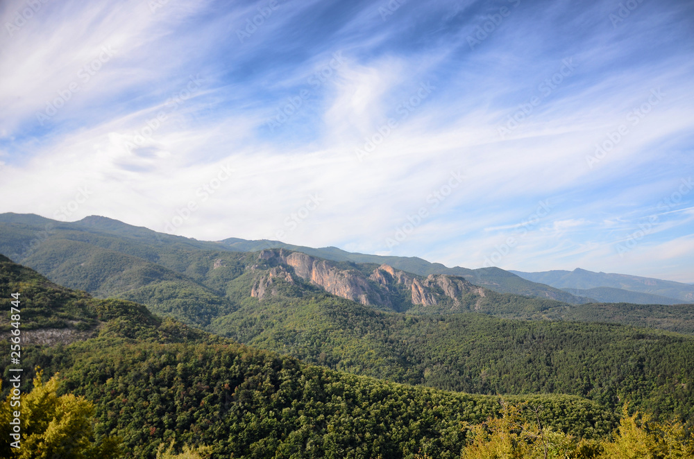 Fototapeta premium Spring time panoramic landscape from Rhodope mountain, Bulgaria. Blue sky with white clouds
