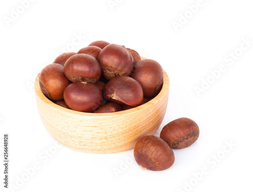 Closeup horse chestnuts in wood bowl isolated on white background, healthy food concept