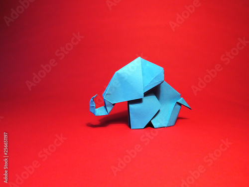 Canvas Print Origami blue elephant on a red background