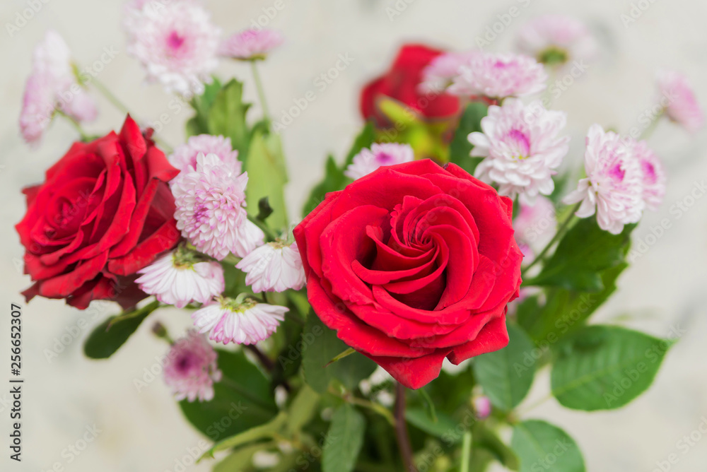 Fototapeta premium bouquet of flowers red roses and asters