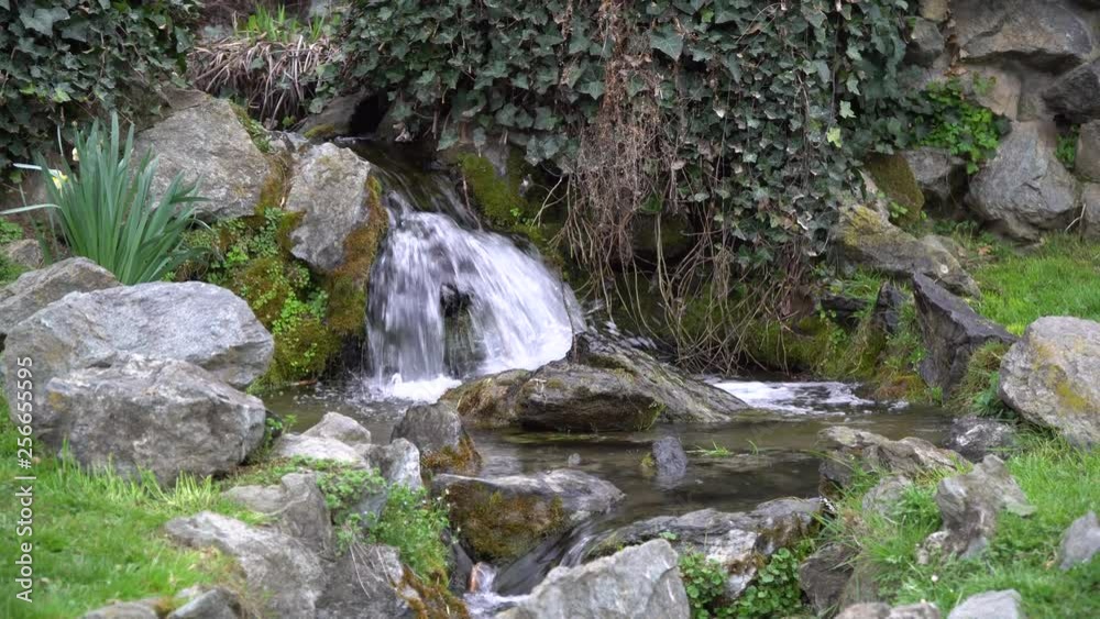 Flowing water stream, water drops and reflection Flowing water stream, water drops and reflection