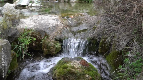 Slow motion Flowing water stream, water drops and reflection