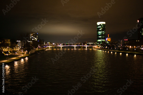 Bright view on the night city, river and skyscraper.