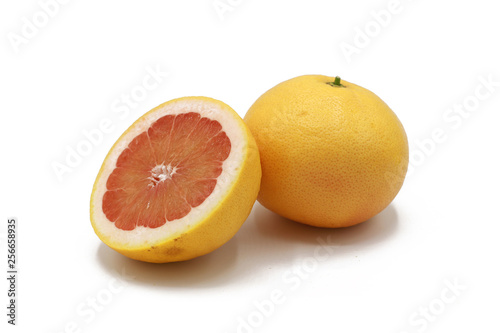 fresh whole and sliced grapefruit  isolated on white