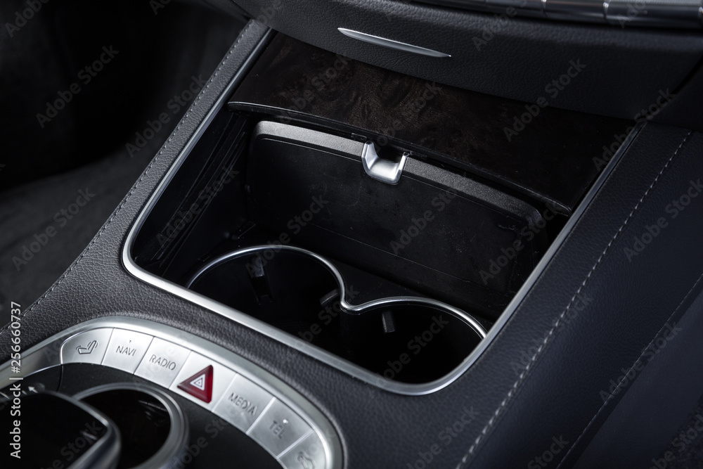 Close up of cup holders in luxury car interior Close up of cup holders in luxury car interior
