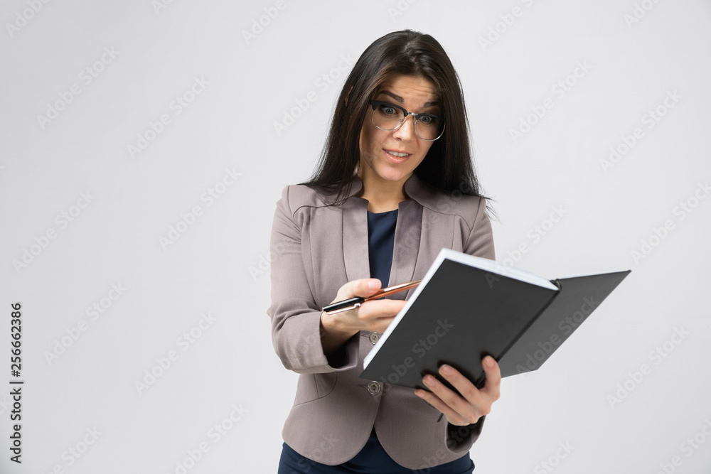 Portrait of brunet in costume with a modern notebook in her hands isolated on background Portrait of brunet in costume with a modern notebook in her hands isolated on background