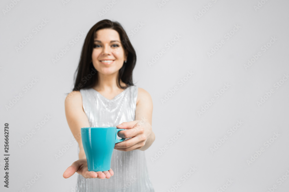 Portrait of brunet smiling woman in blouse holding a cup Portrait of brunet smiling woman in blouse holding a cup