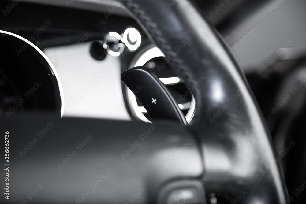 Paddle shifting on black leather steering wheel