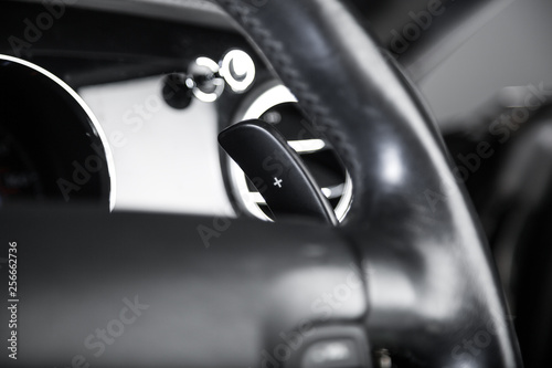 Paddle shifting on black leather steering wheel © camerarules