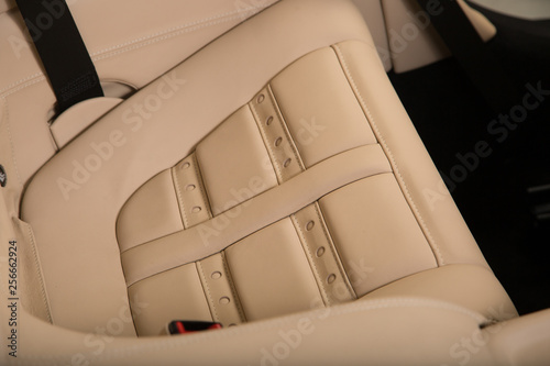 Detail shot of cream leather car seat