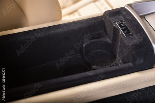 Storage compartment and cup holder in sports car