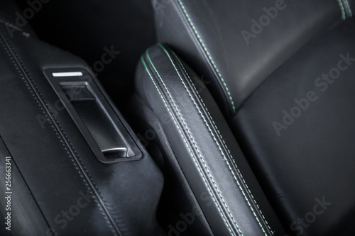 Contrast stitching on black leather car seat