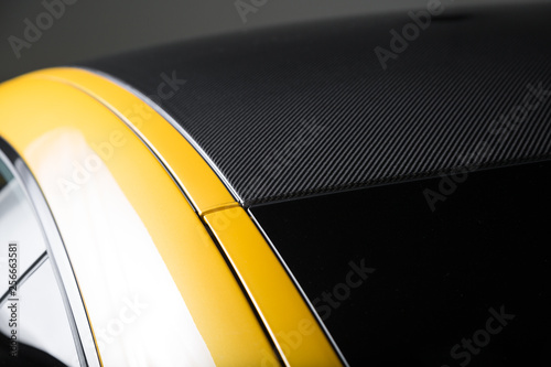 Carbon fibre roof on yellow sports car