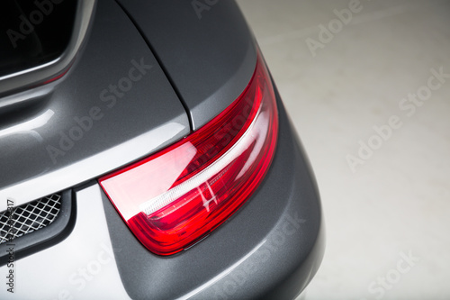 Close up of rear light on silver sports car
