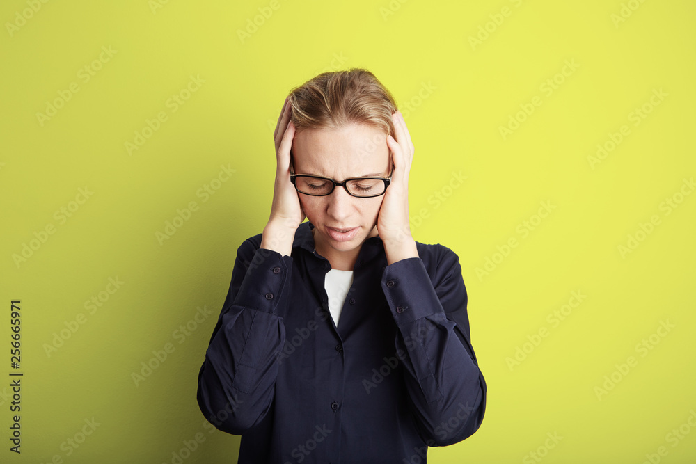 Portrait Handsome Pretty Young Woman Who Grabs Her Head Hands Headache.Empty Yellow Background.Beauty,Shock,Fashion People Photo.Girl Wearing Glasses Closed Eyes Camera Studio Shot.Horizontal Image. Portrait Handsome Pretty Young Woman Who Grabs Her Head Hands Headache.Empty Yellow Background.Beauty,Shock,Fashion People Photo.Girl Wearing Glasses Closed Eyes Camera Studio Shot.Horizontal Image.