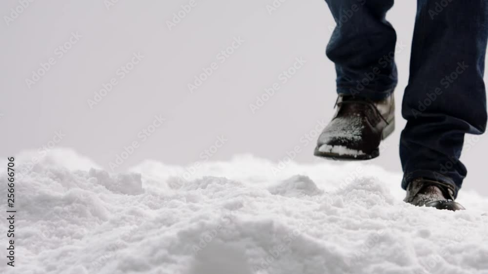 Close-up of people 's feet walking on the snow Close-up of people 's feet walking on the snow