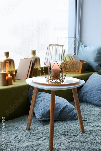 Table with golden candle in...