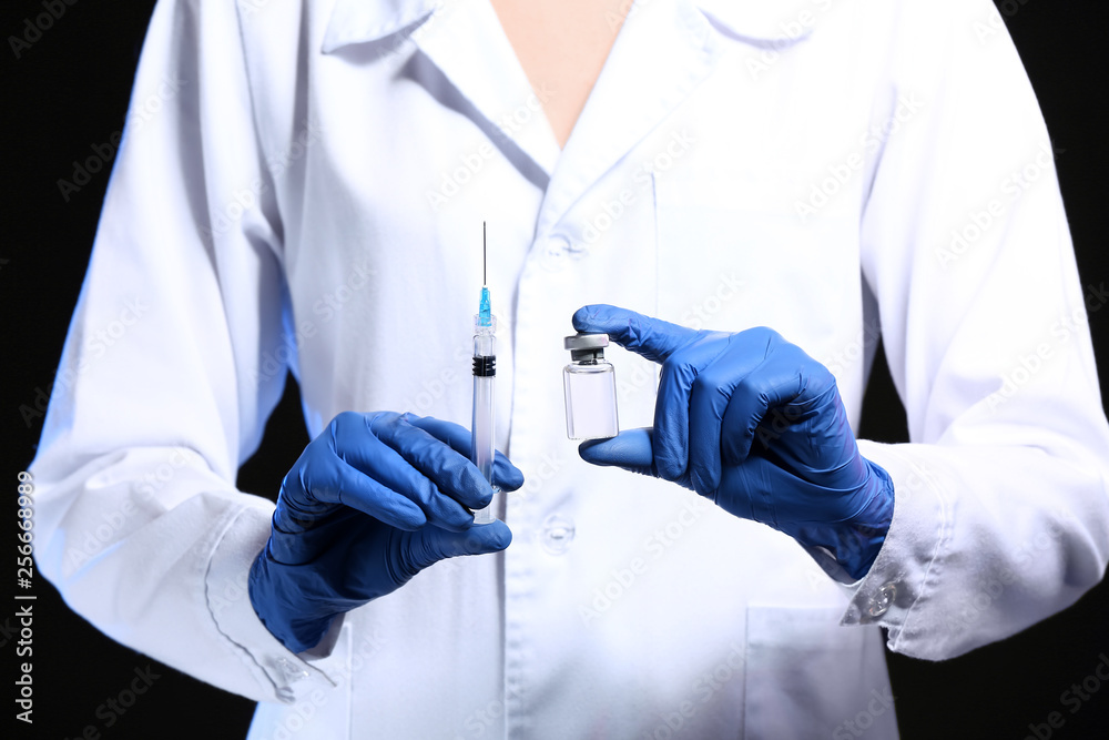 Cosmetologist holding syringe with filler and ampule, closeup Cosmetologist holding syringe with filler and ampule, closeup