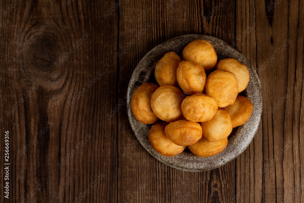 Baursak - traditional Kazakh (Asia) food \ national bread in plate on wooden background, top view