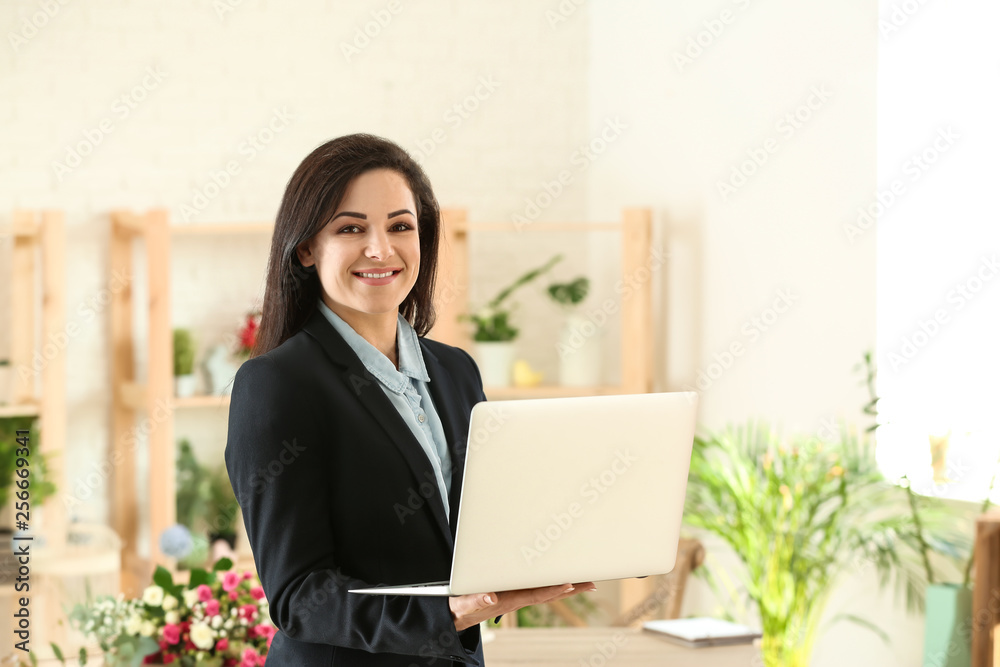 Portrait of beautiful female florist in shop Portrait of beautiful female florist in shop