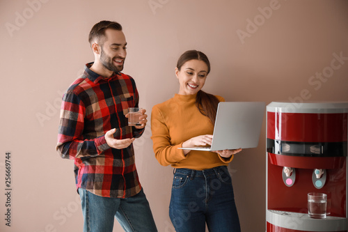 Colleagues near water coole...