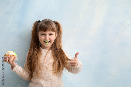 Funny little girl with tast...