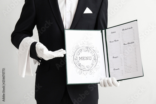 Waiter with menu on light b...