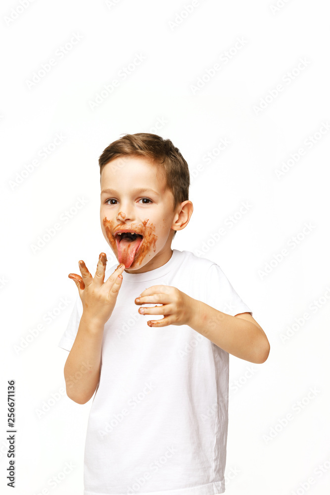 little boy with face and hands in chocolate little boy with face and hands in chocolate