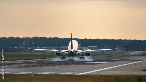 Twin engine jet landing in the morning