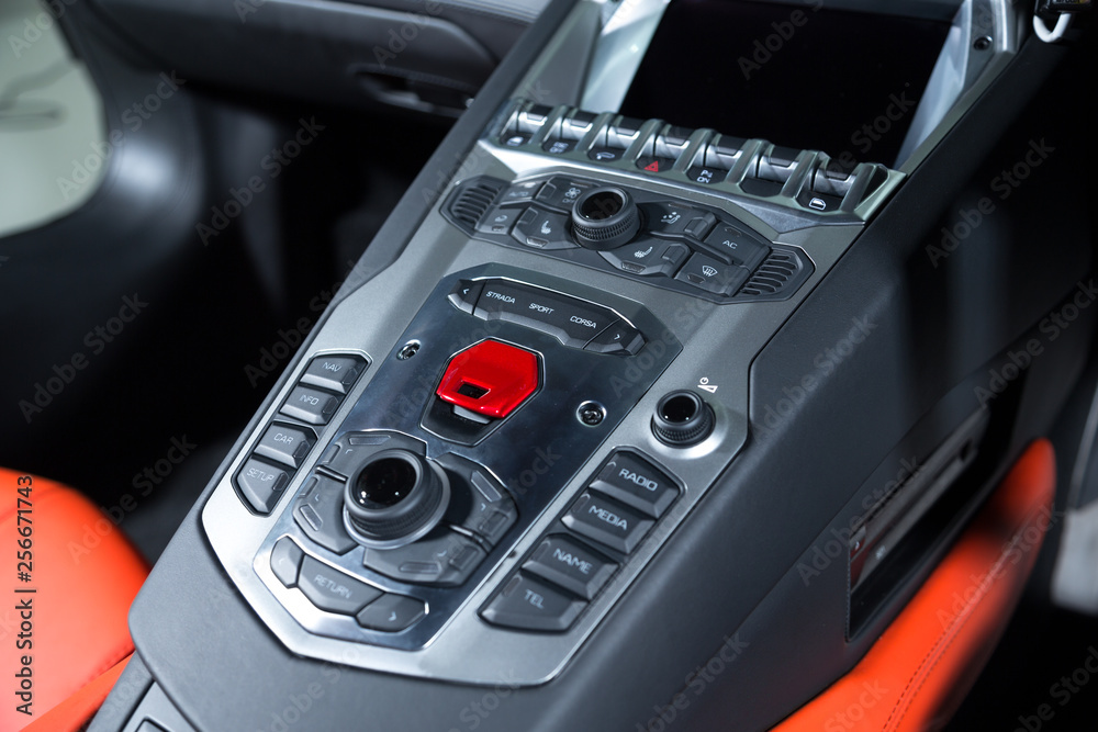 Central tube with control panel in sports car interior Central tube with control panel in sports car interior