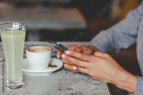 Women Using Smartphone at Coffee Shop. Close up