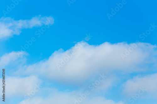 Horizontal photo of winter blue clear sky background with white layered clouds without sun © Andrey