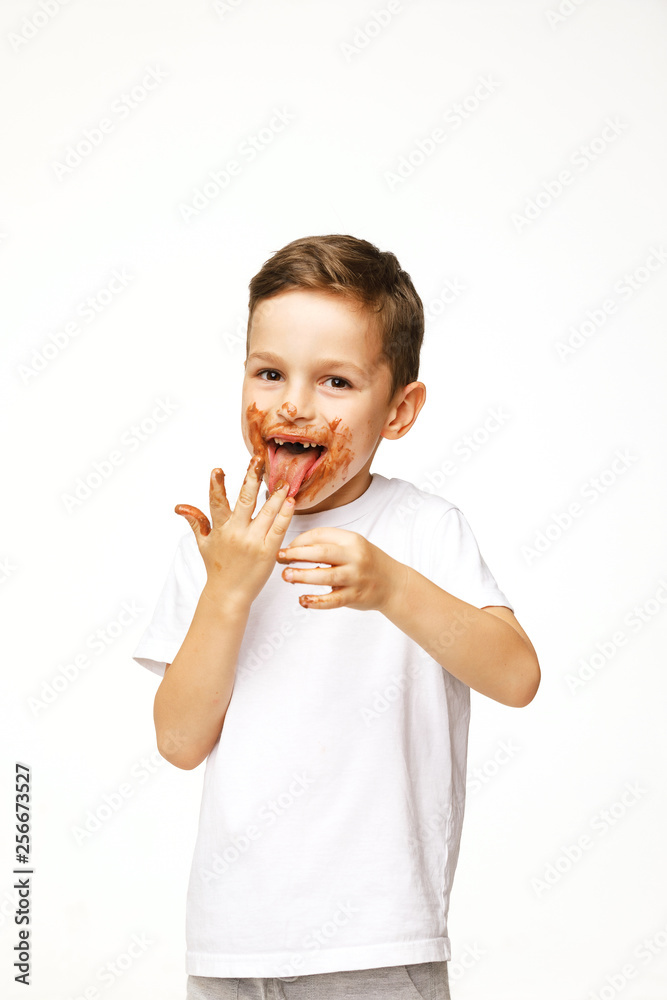 little boy with face and hands in chocolate little boy with face and hands in chocolate
