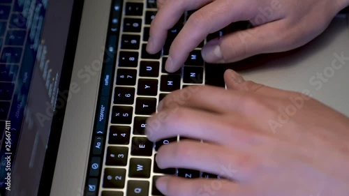 Fingers typing on a Mac keyboard photo