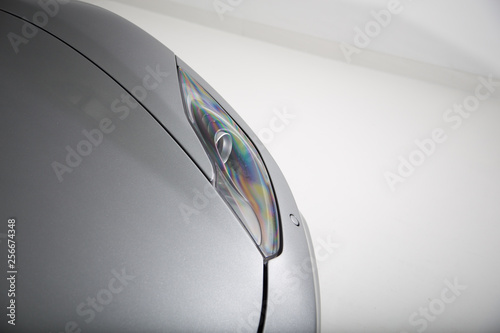 Headlight of silver sports car