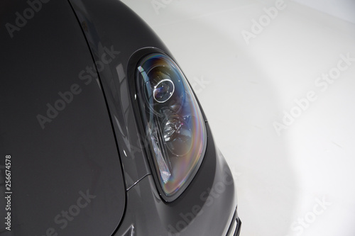 Close up of headlight on grey car