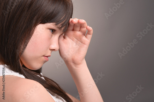 Close-up portrait of girl with dark hair posing