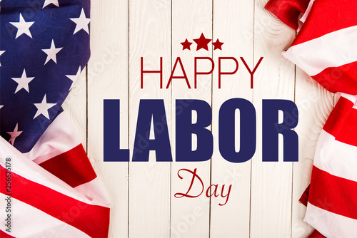 Cuadro en lienzo top view of american flags and happy labor day lettering on white wooden surface
