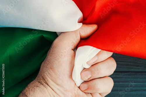 male fist clenches italy flag 