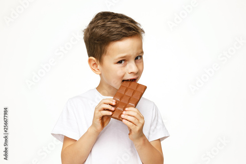little beautiful boy holding chocolate studio shot 