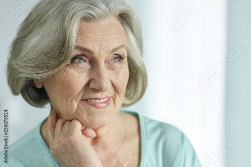Close-up portrait of cute happy senior woman posing