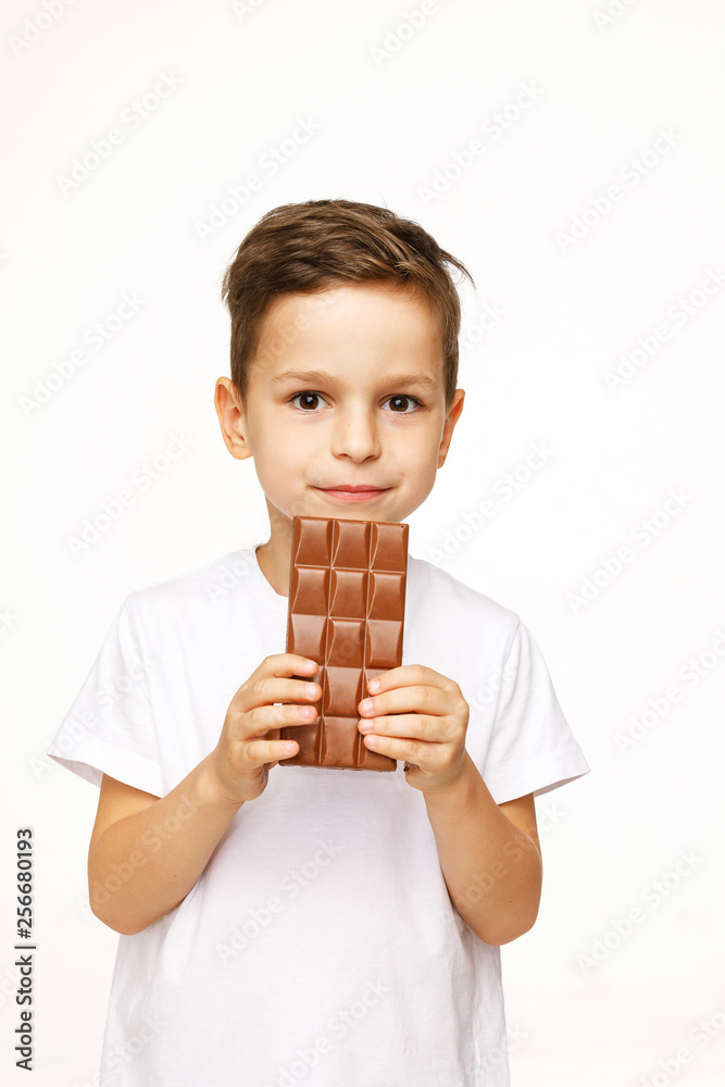 little beautiful boy holding chocolate studio shot 