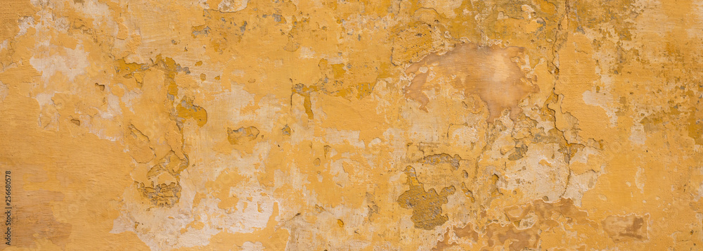 Beige yellow color, painted and faded wall texture grunge background