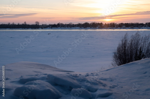 winter sunset over frozen lake