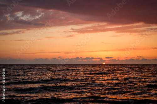 Golden, Fiery sunset on the Black Sea, on the beach. Coast, stones, waves, sun, beautiful sky, clouds. August, Batumi, Georgia. Water, lightness, play. Pink, lilac, crimson © Sea_Inside_Soul