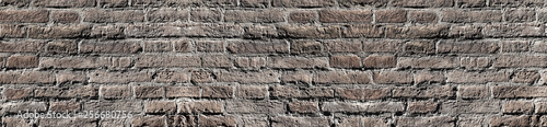 Bleached vintage brick wall texture in contrast lighting for design. Panoramic background for text and image.