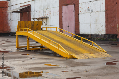Metal ramp for unloading of cars in a warehouse.